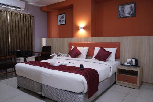 a bedroom with a large bed in a hotel room at PLA RESIDENCY Trichy near Rockfort Temple in Tiruchirappalli