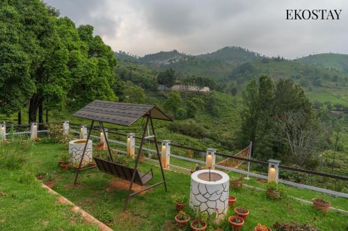 a gazebo with a solar array on a hill at EKOSTAY I Pearl House Villa I 360 Degrees Tea Estate in Ooty
