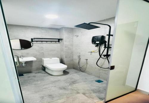 a bathroom with a toilet and a sink and a shower at Coastline Hotel 6 Avenue PortDickson in Port Dickson