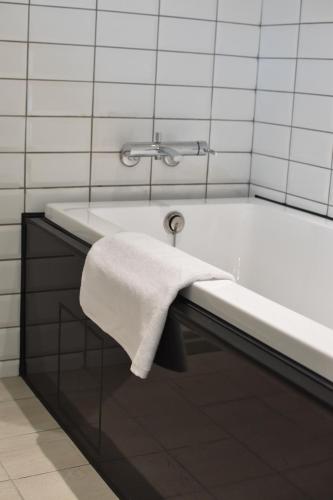 a bathroom with a bath tub with a towel on it at Cheng House in Yuchi
