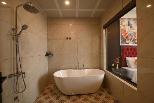 a white tub in a bathroom with a shower at Nhật Long Hotel in Giap Ninh Binh