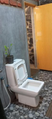 a toilet with a tv on the back of it at Ayanura Ella in Ella