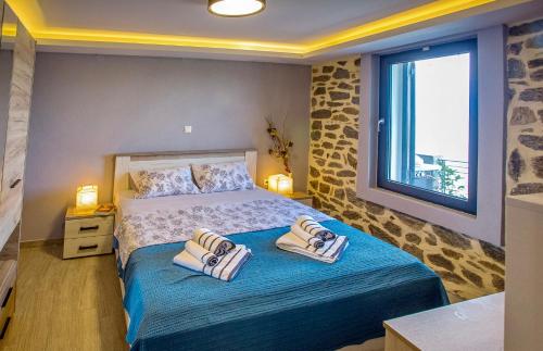 a bedroom with a bed with towels on it at Sunrise Suite in Kavála