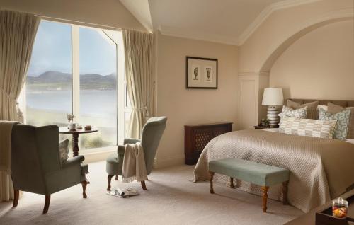 a bedroom with a bed and a large window at Butler Arms Hotel in Waterville