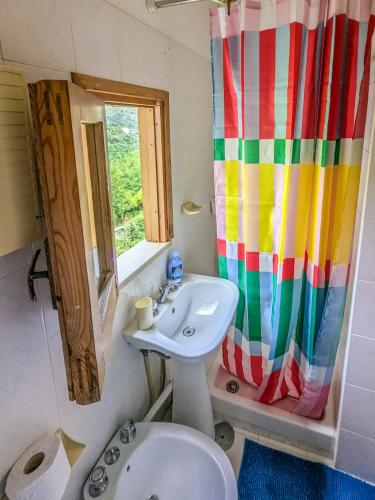 a bathroom with a sink and a shower curtain at Casa Mare e Sole in Vibonati