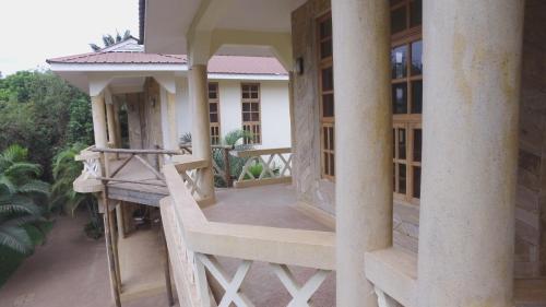 an external view of a house with a balcony at The Paradise In Kilimanjaro in Moshi
