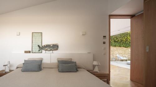 a bedroom with a bed with two pillows at BelleVue Cala Vinyes in Cala Vinyes