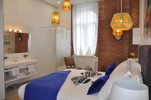 Un dormitorio con una cama y un baño con lavabo. en Indigo Centar, en Zagreb
