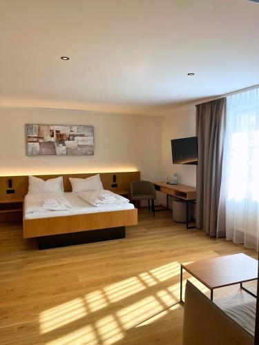 a hotel room with a bed and a desk at Schloss Hotel Zeillern in Zeillern