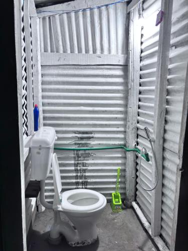 a bathroom with a toilet and a shower at Kishangangacampsgurez in Wāmpor