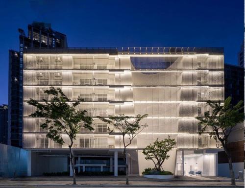 a white building with trees in front of it at BLU 395 Ari-Saphan Khwai in Bangkok