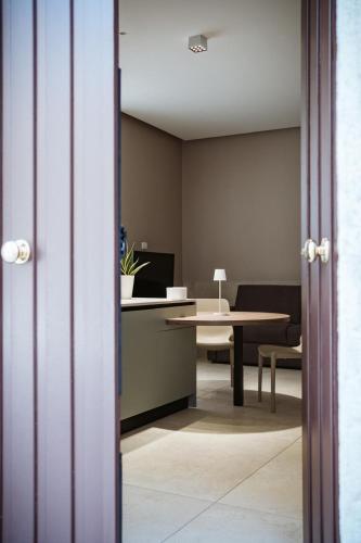 an office with a desk and a table with a chair at MEANDRI Apartment in San Severo