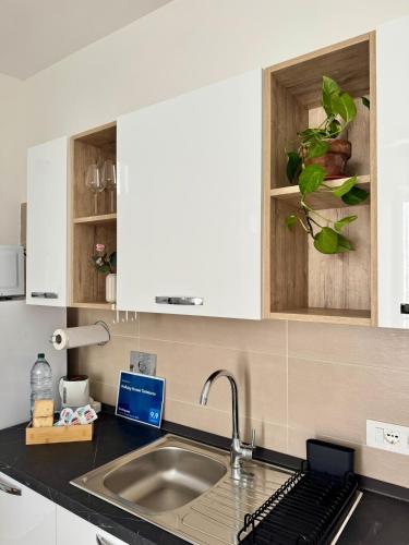 a kitchen with white cabinets and a sink at Holiday Home Tarinuzza in Lipari