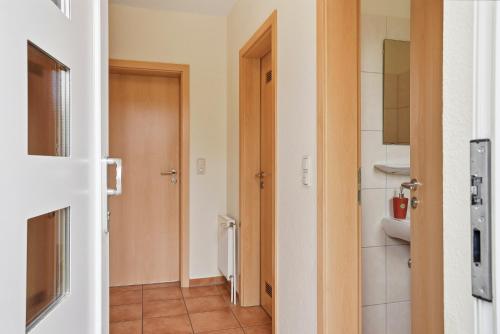 a room with a bathroom with a toilet and a door at Meeresbrise in Norddeich