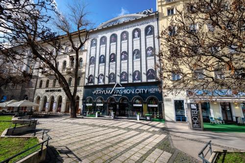 a large building with a sign on the side of it at Fashion City Hotel Superior in Budapest