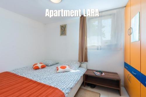 a bedroom with a bed with two pillows on it at Apartments Salak in Pula