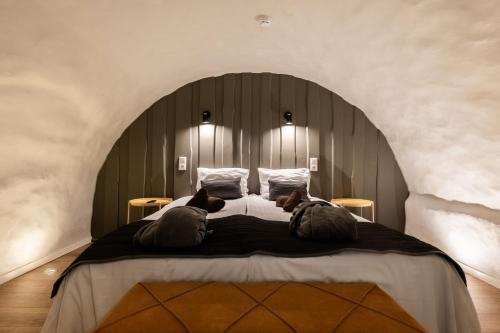 a bedroom with a large bed with two teddy bears on it at Johan Suites & Spa in Kuressaare