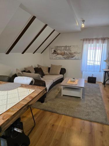 a living room with a couch and a table at Apartman Gorski raj in Fužine