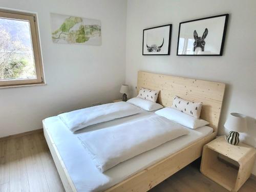 a bedroom with a large bed with white sheets at Rauchhof in Auer