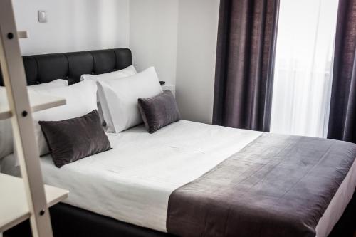 a bedroom with a large bed with white sheets and pillows at Anjo Azul in Lisbon