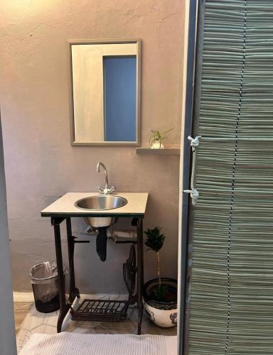 a bathroom with a sink and a mirror at 1054 Holiday Home in Kasane Airport