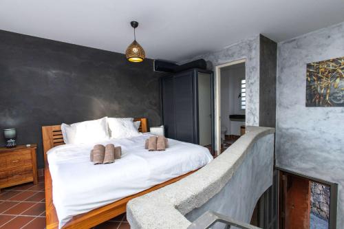 a bedroom with a large white bed in a room at Charming Duplex Mauritius' Little Venice in Terre Rouge