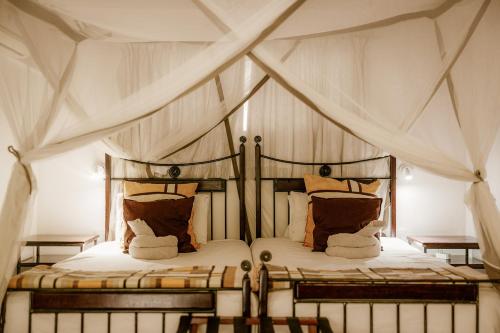 เตียงในห้องที่ Kasane Self Catering