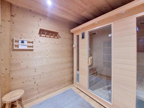 a wooden room with a sauna with a chair at Gervonne 2 in Morzine