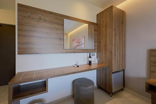 a room with a wooden counter and a mirror at Sunset Hotel in Ouranoupoli