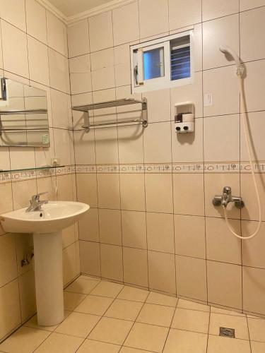 a bathroom with a sink and a shower at Jin Sha Ting Hai Homestay I in Nangan