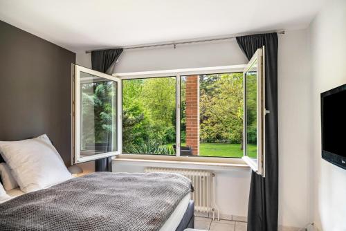 a bedroom with a bed and two windows at Ferienwohnung Sigi in Traben-Trarbach