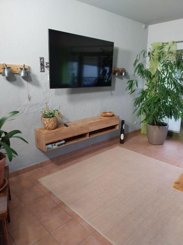 a living room with a flat screen tv on a wall at Pension am Bernsteinmuseum Ferienwohnung in Ribnitz-Damgarten