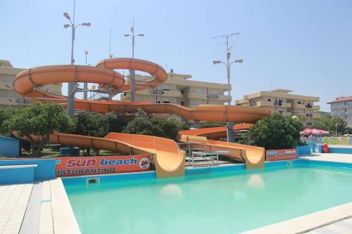 a water slide at a resort with a swimming pool at Hotel Admiral in Cesenatico
