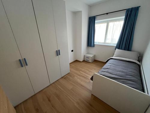 a small bedroom with a bed and a window at Casa Vian in Vigo di Fassa