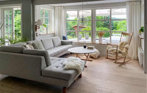 a living room with a couch and a table at 3 Bedroom Beautiful Home In Bryrup in Bryrup