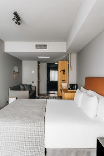 a bedroom with a large bed and a living room at Uma House by Yurbban Trafalgar in Barcelona