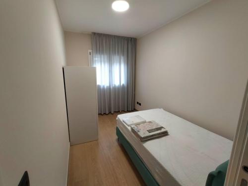 a small room with a bed and a refrigerator at Sole & Mare in Palmi