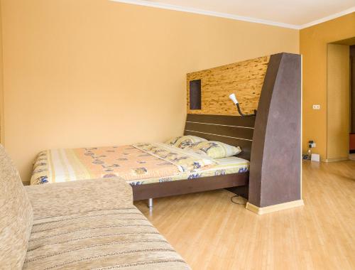 a small bedroom with two beds and a lamp at Central Studio Tatiana in Kharkiv