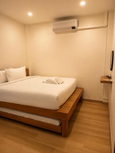 a bedroom with a bed and a air conditioner at Cloud Nest House Betong in Betong