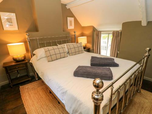 a bedroom with a bed with two towels on it at Well Cottage in Chipping Norton