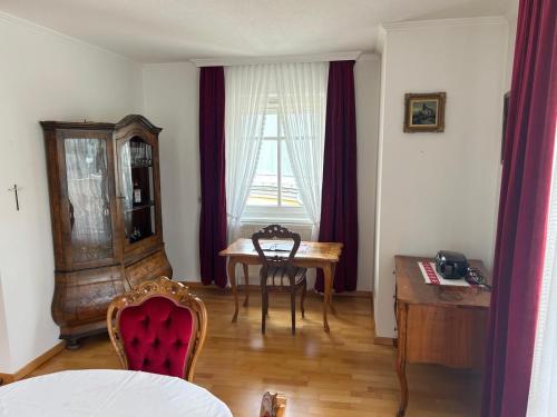 a dining room with a table and a table and chairs at Bergblick Apartment in Lienz