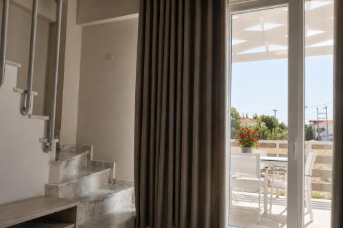 a bathroom with a sliding glass door to a patio at Casale Luxury House - Luxury Garden Maisonettes in Nikiti