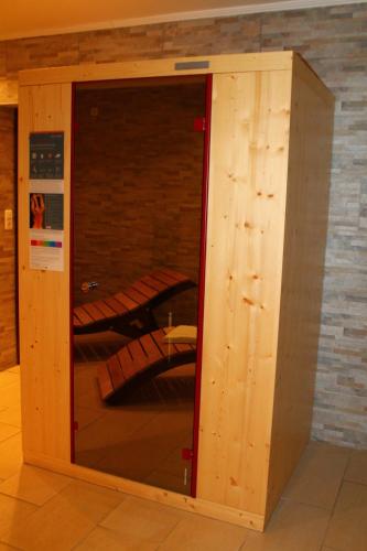 a wooden enclosure with a glass door in a room at Lachtalhaus in Lachtal
