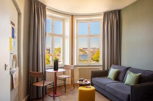 a living room with a couch and a large window at Bob W Stockholm Södermalm in Stockholm