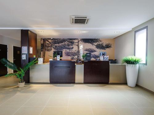 a lobby with a cashier counter in a store at Adagio Nice Centre in Nice