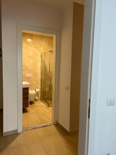 a bathroom with a shower and a toilet and a sink at Sea View Marjana Apartment in Skataj