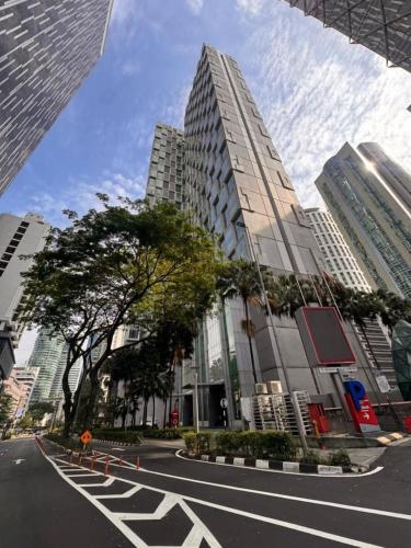 an empty street in a city with tall buildings at Soho Suites KLCC by Leala in Kuala Lumpur