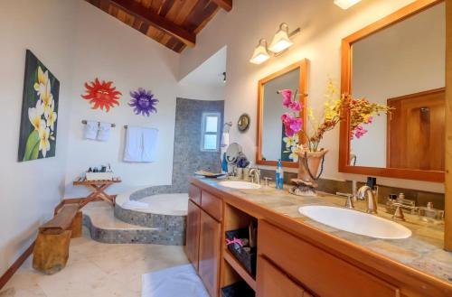 a bathroom with two sinks and a bath tub at Indigo Belize Beach 2C in San Pedro