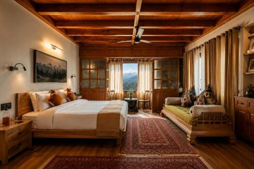 a bedroom with a large bed and a couch at The Riverside Barn Srinagar in Srinagar