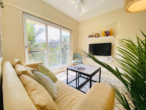 a living room with a couch and a table at ConnektHomes - Modern2Bed-BandraArea in Mumbai